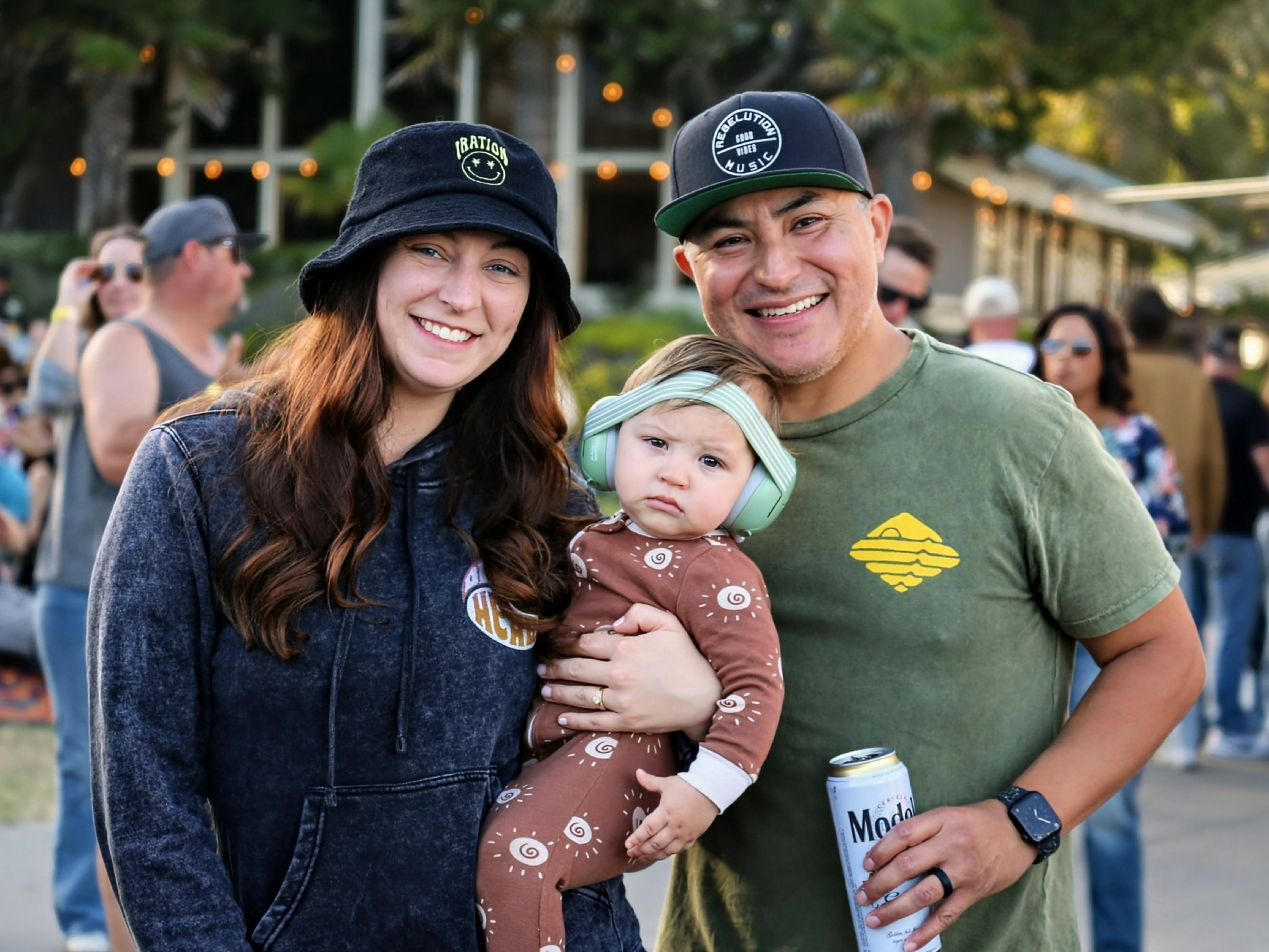 Young family with baby in ear muffs at the show