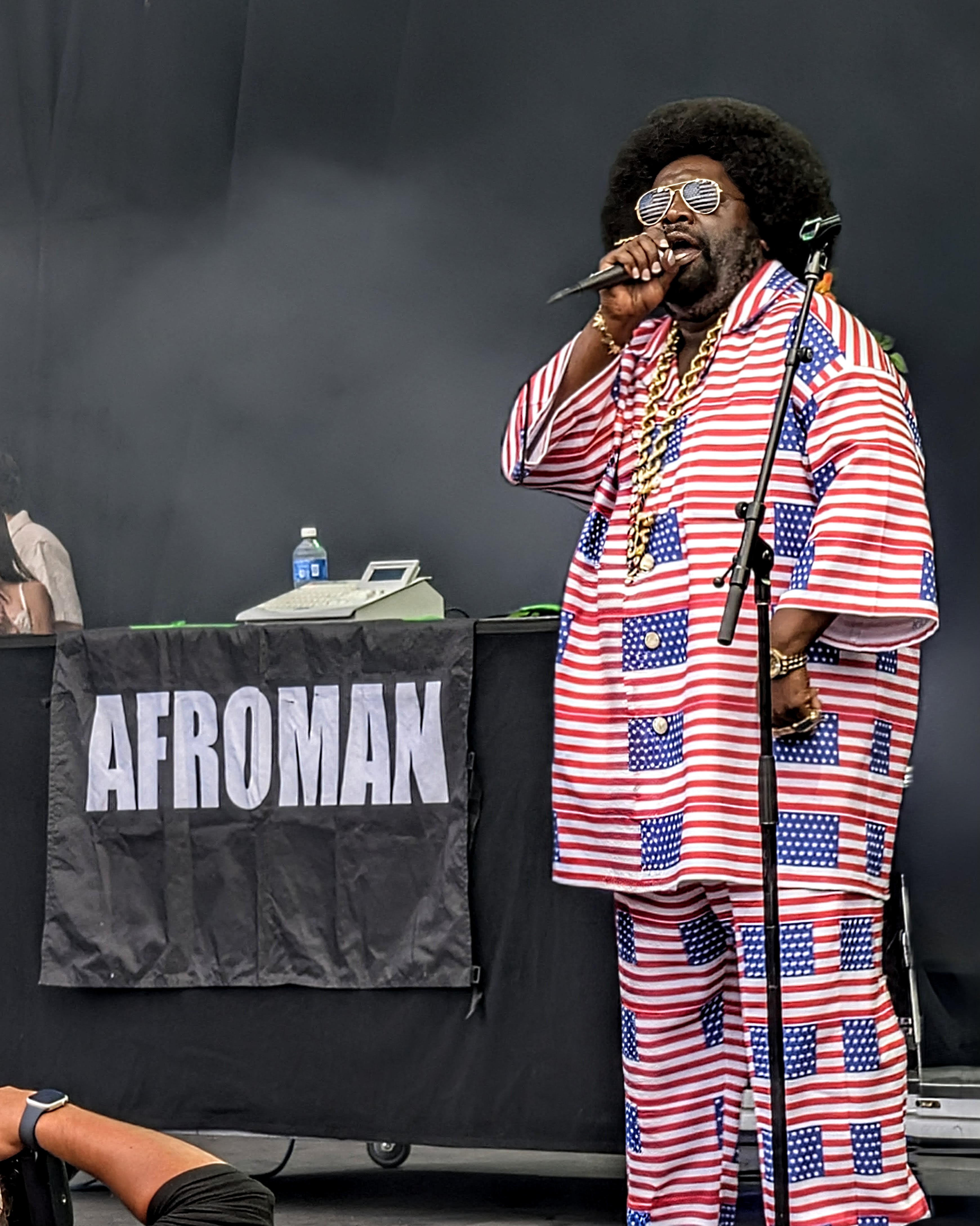 Afroman performing in an American flag suit beside his beat machine