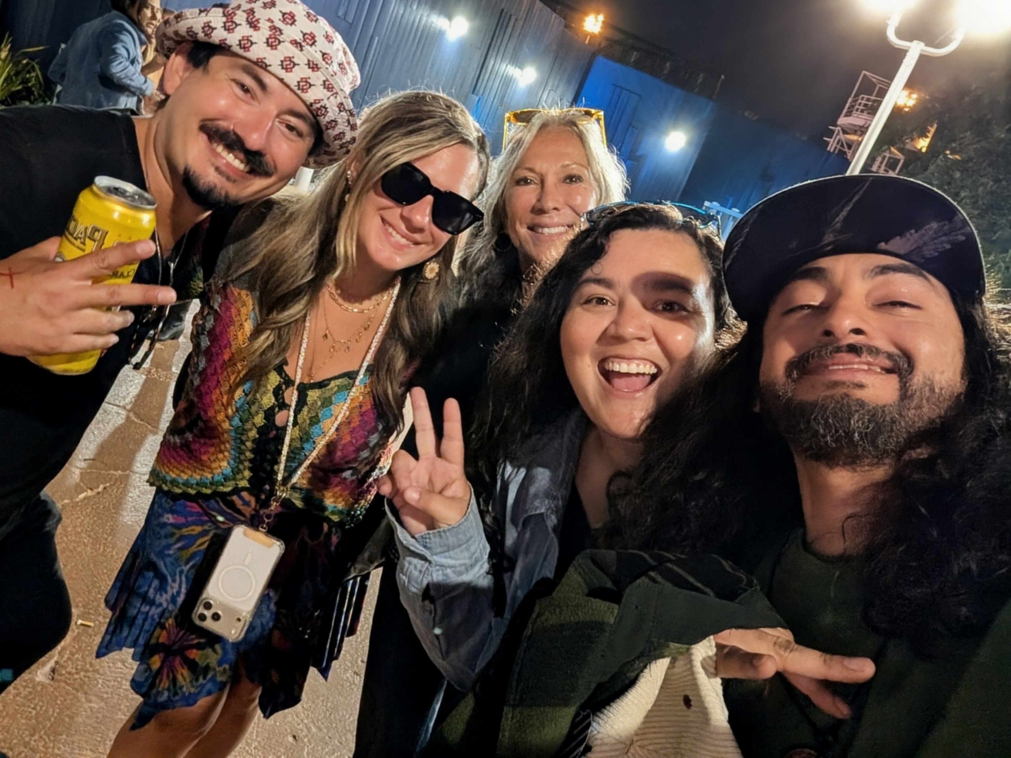 Angel, Heather, and friends smiling together after the concert