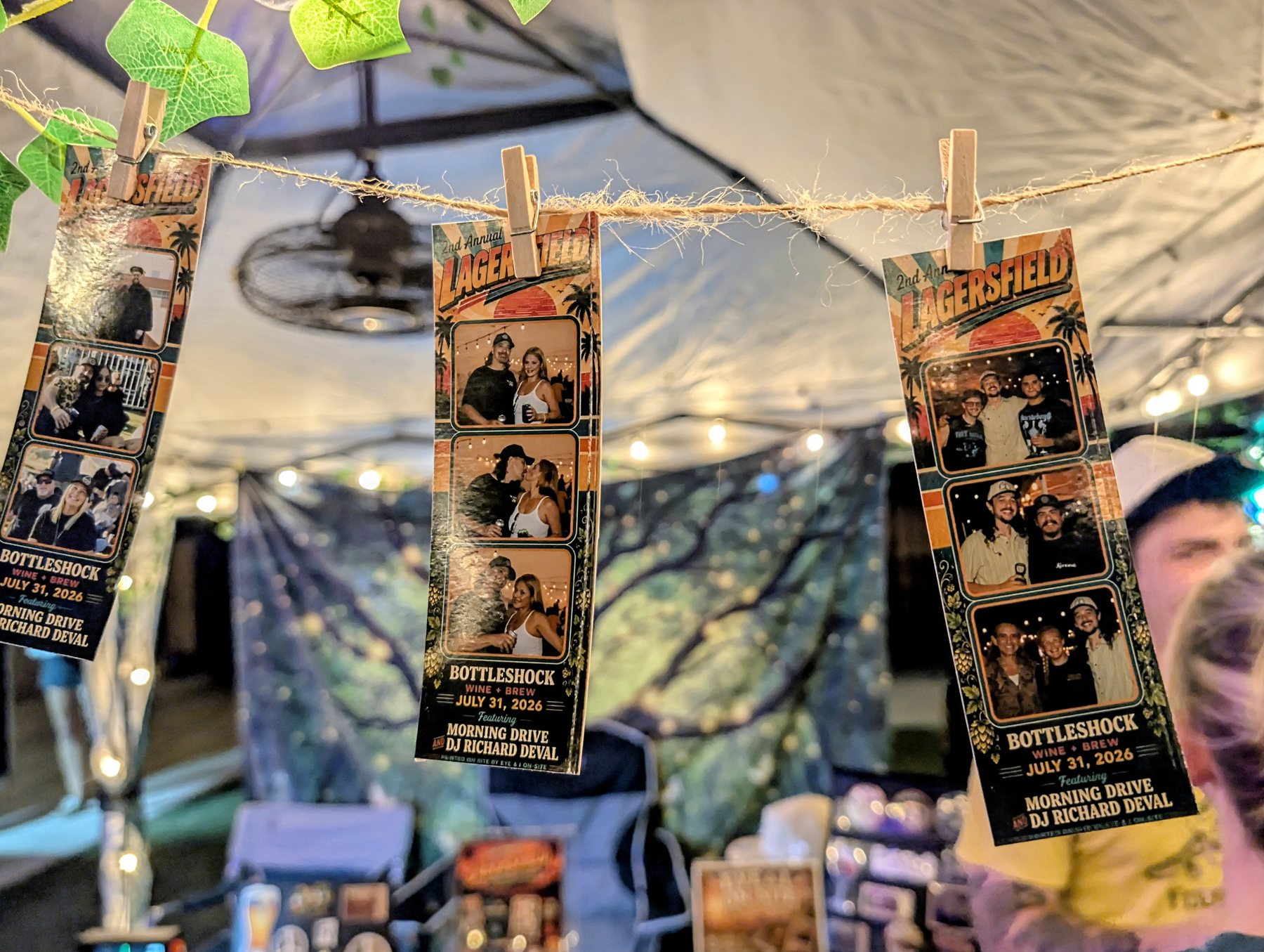 Lagersfield photo strips hanging on a clothesline in the Eye & I On-Site booth